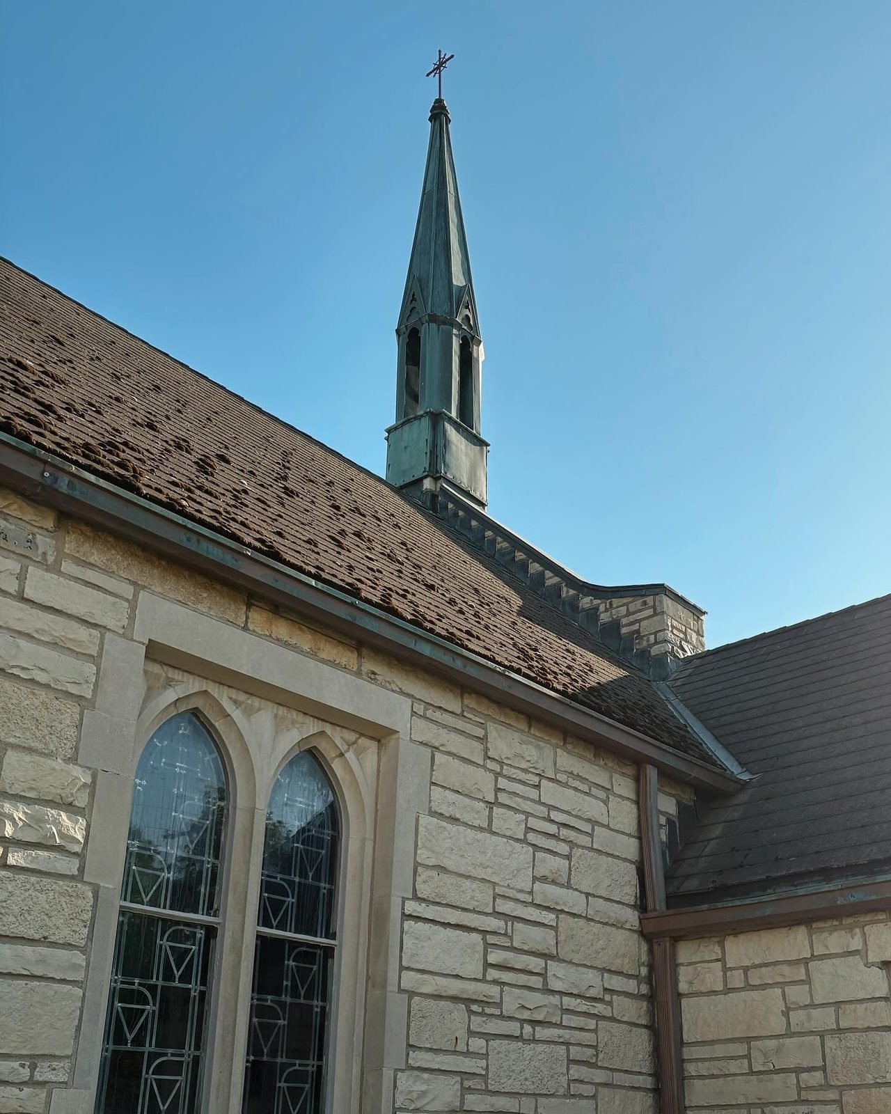 The church steeple against a blue sky