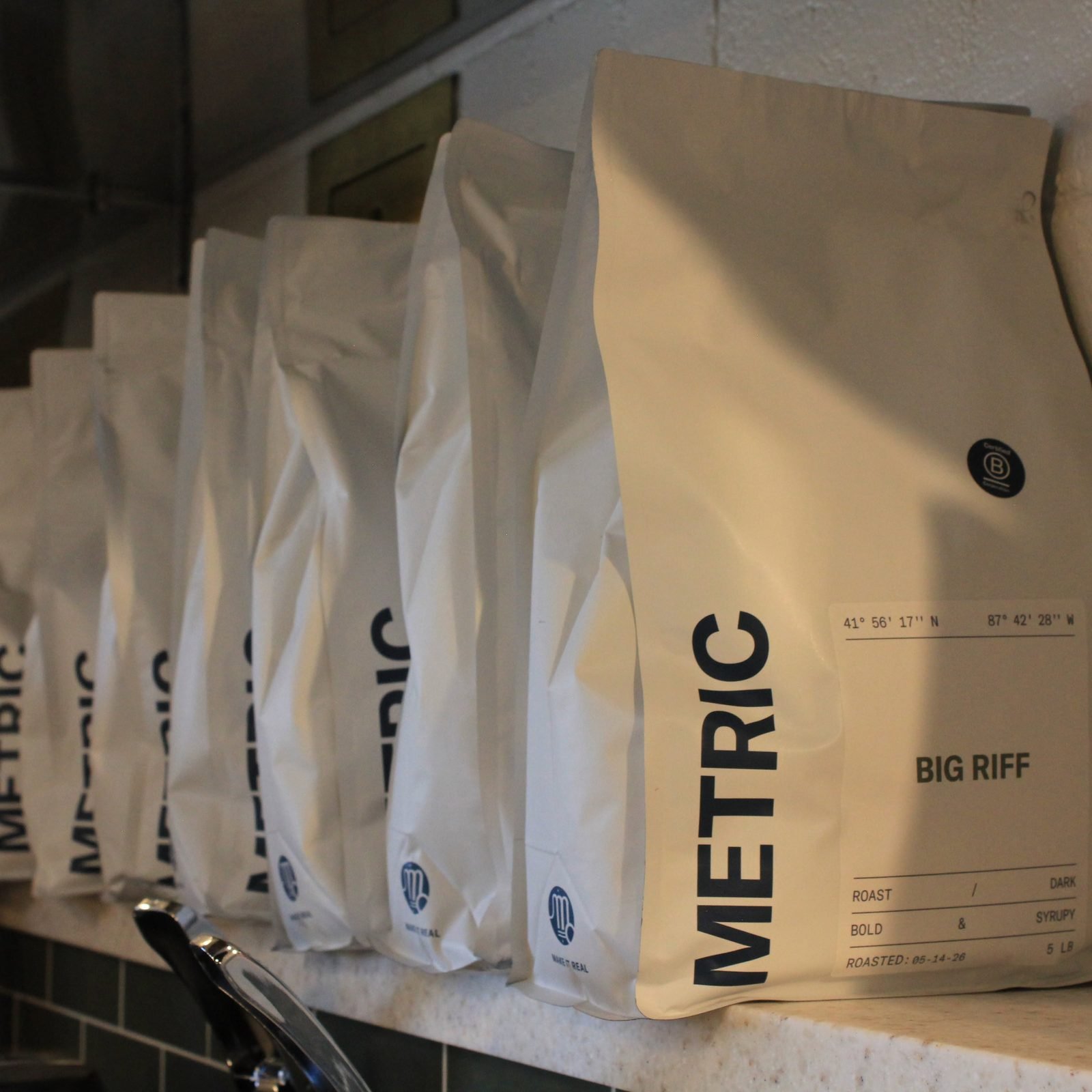 A bag of Metric coffee beans on the counter